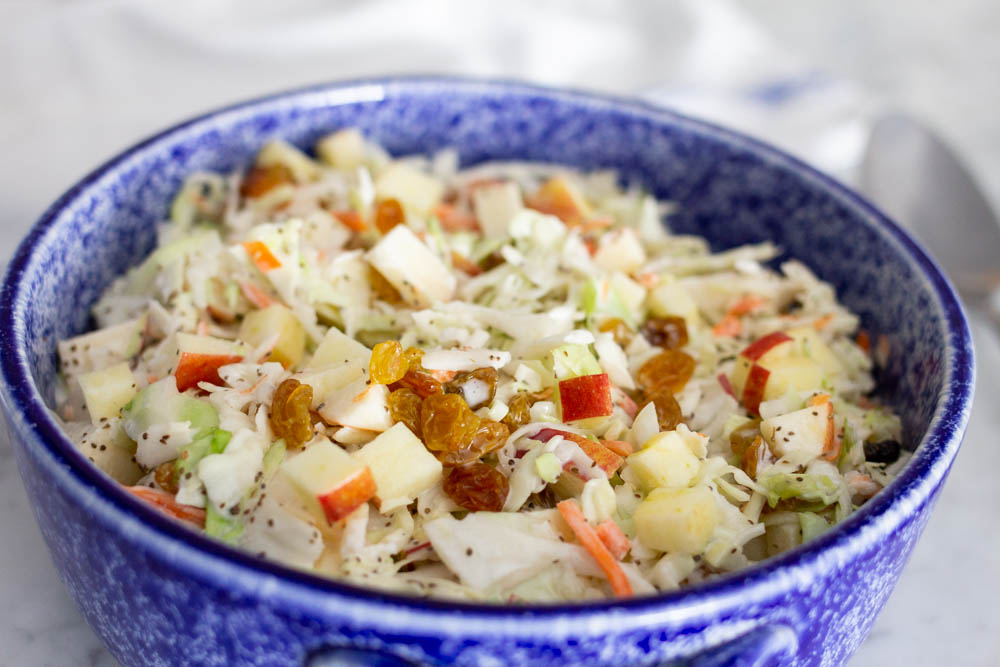 coleslaw made with apples and golden raisins