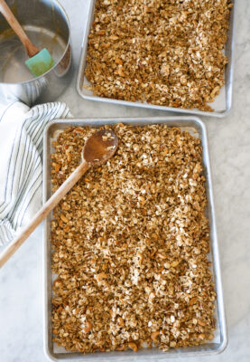 Ingredients for Peanut Butter Granola on two baking sheets ready to bake.