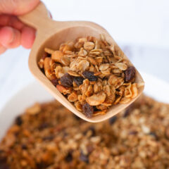 Peanut Butter Granola in wooden scoop - up close