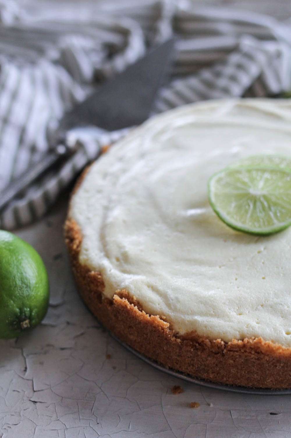 Key Lime pie with towel and fresh limes