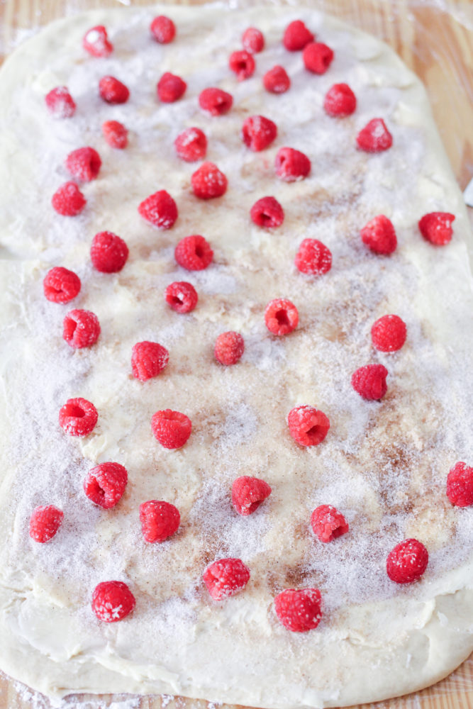 fresh raspberries on roll dough