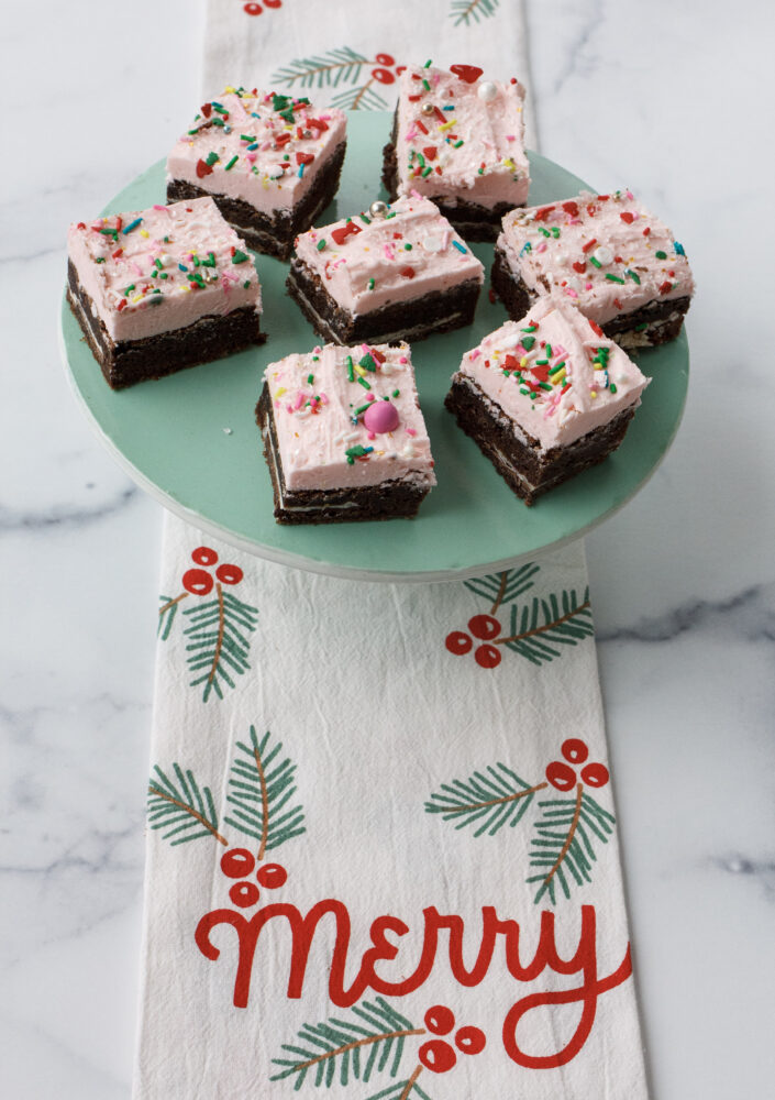 Brownies with pink frosting and peppermint bark