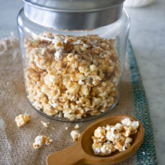 The Very Best Crunchy Caramel Corn in glass container with scoop