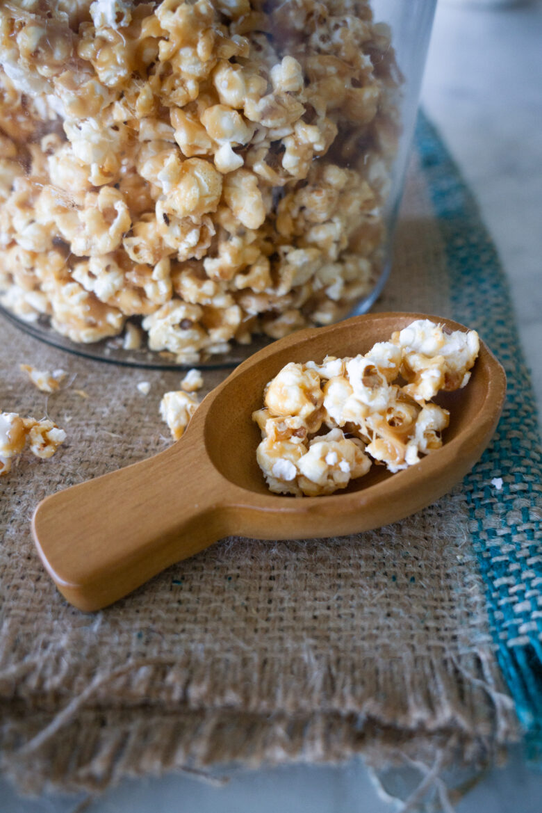 Close-up: The Very Best Crunchy Caramel Corn in glass container with scoop