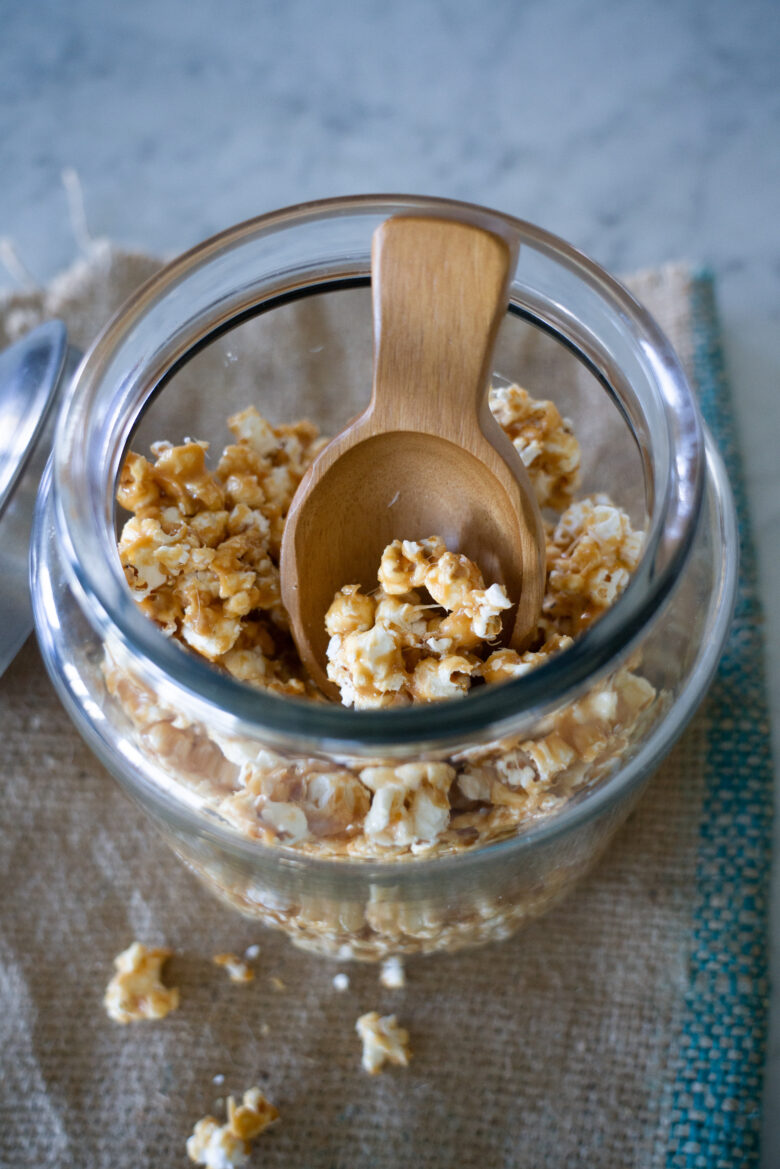 The Very Best Crunchy Caramel Corn looking into glass container