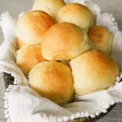 basket of potato rolls with off white napkin