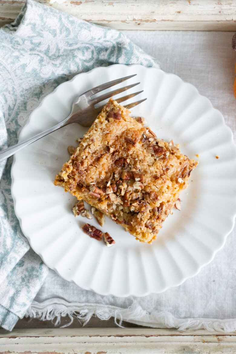 Pumpkin Dump Cake with nuts on a white plate with fork