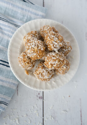 Coconut protein bites in small white bowl.