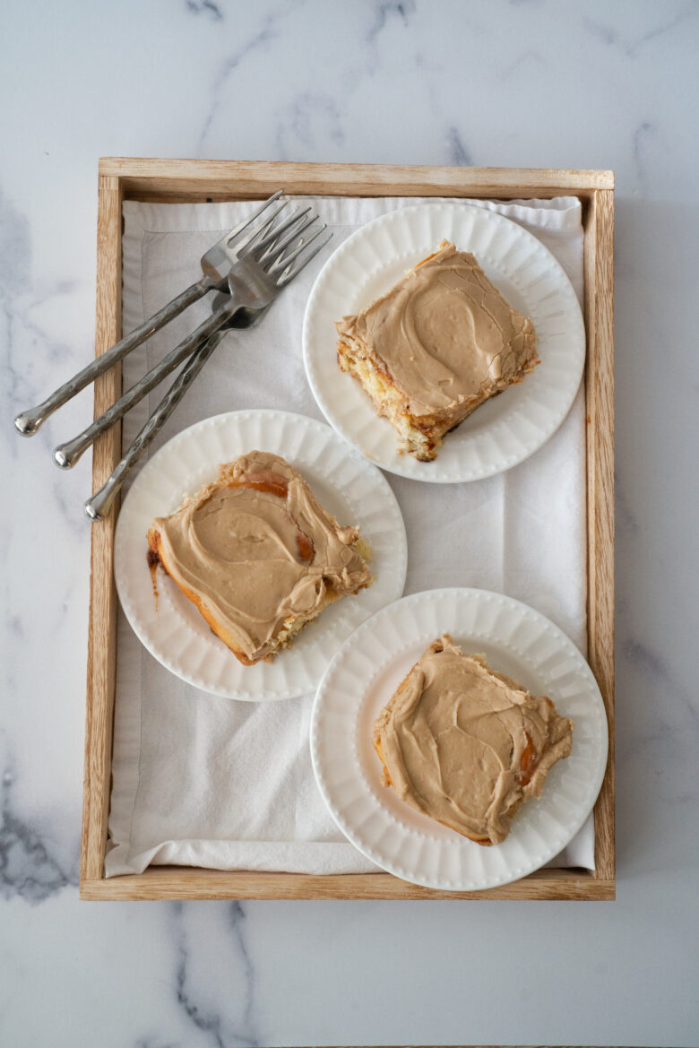 maple cinnamon rolls on a tray with forks