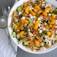 White serving bowl and serving spoons with Asian Wonton Chicken Salad
